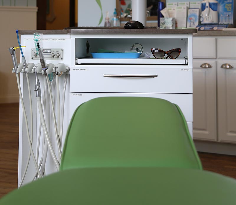 dentist chair sitting in front of equipment